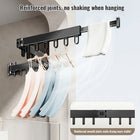 Tendedero plegable con ropa colgada