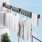 Tendedero de pared plegable gris con tres barras